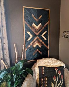 a living room with a chair, potted plant and decorative artwork on the wall