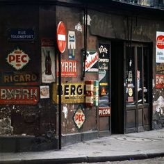 an old building with many signs on the side of it's windows and doors