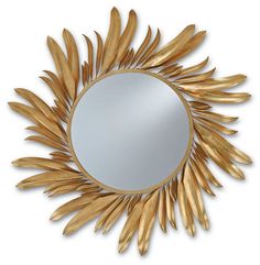 a mirror that is sitting on top of a white wall with gold leaf decorations around it