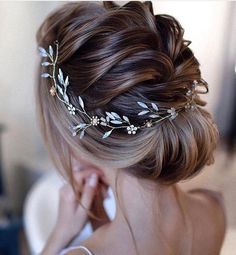 a woman wearing a hair comb with flowers in it