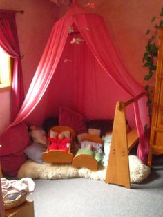 a pink canopy bed in a child's bedroom