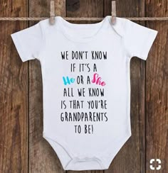 a white baby bodysuit that says we don't know if it's a no or a she all we know is that you're grandparents to be