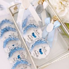 blue and white wedding favors in a glass box