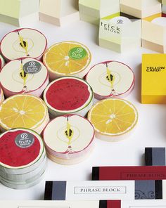 several pieces of fruit sitting next to each other on top of a white table covered in post - it notes