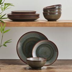 a wooden shelf with plates and bowls on it