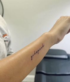 a person with a small tattoo on their arm