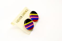 1970's NOS Black Multi-colored Striped Circle Stud Earrings. Super cute in brand new old stock condition. Never worn. I have 6 of these in total. Listing includes one set of earrings/sale. Retro Multicolor Clip-on Earrings, Retro Rainbow Earrings For Gift, Circle Stud Earrings, Plastic Ring, Spiral Pattern, Circle Earrings Studs, Winston Salem, Circle Studs, Vintage Lucite