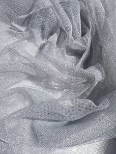 "Metallic silver netting soft tulle fabric usable for apparel,accessories and interior designing. 45 inches wide. Beautifully made to use for costumes, decorations, weddings and much more. Width : 60\" inches Color : Butter yellow Content : Poly Thank you for your coming! Please read policy before placing an order. Please contact us via ETSY Conversations for more details. Fabrics are sold by the yard. We will continue length of multiple yards . It will come in one piece of the multiple yards yo Elegant Silver Tulle Fabric For Party, Silver Fabric, Shiny Fabric, Printed Backgrounds, Interior Designing, Soft Tulle, Net Fabric, Silver Feather, Fabric Suppliers