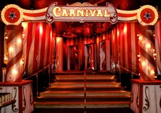 the carnival stage is decorated with red and white striped curtains, lights, and stairs