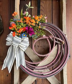 a bunch of flowers sitting on top of a rope