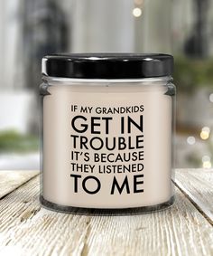 a candle that is sitting on top of a table with the words if my grandkids get in trouble it's because they listened to me