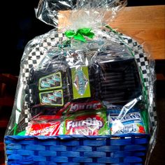 a blue basket filled with candy and snacks