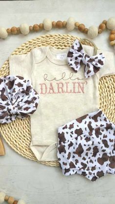 This is perfect for a cute summer outfit, coming home, birthday parties, and baby shower gifts, especially a cowgirl baby shower! The newborn pictures will be so cute! This sweet little oatmeal bodysuit is embroidered Hello Darlin' in a sweet blush pink. The matching bummies are in a fun cow print, stretchy, and so sweet! The hand-tied bow and turban is a perfect finish. The bummies are handmade in a matching stretchy, easy to wash fabric. Outfits fit true to size.  Newborn fits best 6-9 lbs 0/3 Cute Diaper Cover For First Birthday, Baby Girl Western Outfits, Western Baby Girl Outfits, Pink Hospital, Fabric Outfits, Western Baby Girls, Country Baby Girl, Hello Darlin