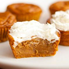 several cupcakes with frosting on a white plate