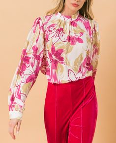 Our Ashley floral blouse is both sophisticated and fun!  A stunning abstract floral print in pink and taupe on a white base gives this blouse an edge, while billowy sleeves offer a feminine appeal.  Gathering at the collar, sleeves and shoulders add that extra flair.  Effortlessly pair this blouse with jeans for a casual look or dress up with your favorite bottoms. Pink Blouse With Blouson Sleeves For Fall, Pink Fitted Blouse With Blouson Sleeves, Pink Workwear Top With Blouson Sleeves, Pink Blouson Sleeve Top For Work, Cream Floral Print Feminine Blouse, Chic Cream Blouse With Floral Print, Trendy Cream Floral Print Tops, Elegant Pink Blouse With Floral Print, Chic Pink Blouse For Fall