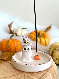 a white plate topped with a halloween decoration