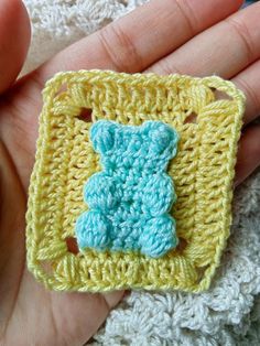 a crocheted square with a blue teddy bear on it