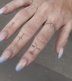 a woman's hand with a tattoo on it, and her fingers are shown