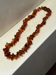 a necklace made out of glass beads sitting on top of a counter