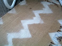 an upholstered chair with white paint on the seat and backrests that have been stripped off