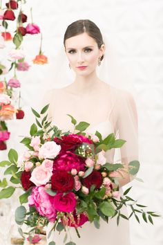 a woman holding a bouquet of flowers in her hands