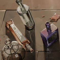 an assortment of items sitting on top of a glass table next to a bottle and lighter