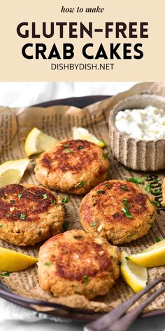 three crab cakes on a plate with lemon wedges