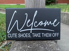 a sign that says welcome cute shoes, take them off on the side of a tree