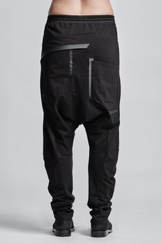 "Black J Shaped Cotton Trousers with Elastic Waistband__ // EXPRESS DELIVERY ONLY __Elastic Waistband with Drawstring __J Shaped Legs __2 Front Pockets __2 Back Bonded Pockets __Asymmetrical Hidden Front Closure model__ bust 92 (36\"), waist 72 (28\"), hips 102 (40\"), biceps 28 (11''), height 177 (5'8\"), kg 65 (143 lbs) model wears size M | color: black fabric__ 100 cotton care__ delicate machine wash at 30 c wash inside out use cool iron do not tumble dry sizing__ size XS (US 4, EU 34, IT 40, Black Parachute Pants With Tapered Leg And Belt Loops, Edgy Black Tapered Leg Pants, Black Tapered Leg Pants With Hip Pockets, Black Tapered Pants With Hip Pockets, Urban Black Pants With Belt Loops, Black Cotton Pants With Belt Loops, Black Tapered Leg Pants With Belt Loops, Black Fitted Drop Crotch Bottoms, Fitted Black Harem Pants For Streetwear