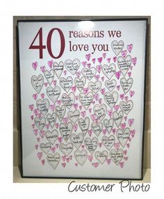 a sign that says 40 reasons we love you with hearts in pink and red on it