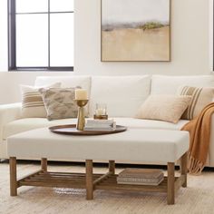 a living room with a white couch and coffee table