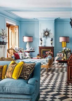 a living room filled with furniture and decor on top of a checkered floored floor