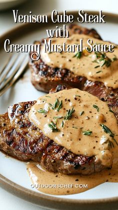 two steaks with creamy mustard sauce on a plate