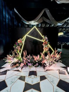 an elaborately decorated table with flowers and greenery