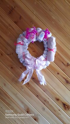 a wreath made out of toilet paper on top of a wooden floor