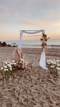 an outdoor wedding setup on the beach with white flowers and pamolite garnishes