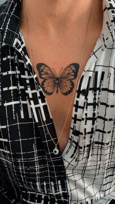 a woman with a butterfly tattoo on her chest