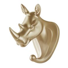 a gold rhino head mounted to the side of a white wall with a black nose