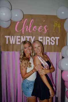 two beautiful young women standing next to each other in front of a sign that says choes twenty first