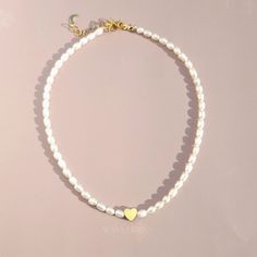 Indulge in effortless everyday luxury with our handmade pearl necklace. Featuring natural pearls, a gold-filled clasp, and a radiant gold-plated heart, this piece effortlessly enhances your daily look with timeless charm. Handmade in USA. DETAILS Water Resistant Material: Gold filled, freshwater pearls Length 15 inches plus 1.5 inches adjustable extender Note: As each piece is totally handcrafted and made with natural pearl, dimensions and shapes can slightly vary Handmade Pearl Necklace, Extraordinary Jewelry, Gold Bond, Everyday Luxury, Sweet Love, Natural Pearl, Everyday Luxuries, Oils For Skin, Love Necklace