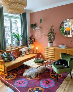 a living room filled with furniture and a cat laying on top of a rug in front of a window