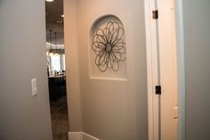 a white door with a metal flower decoration on the front and side panels, in a home hallway