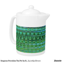 a teapot with green and blue designs on it