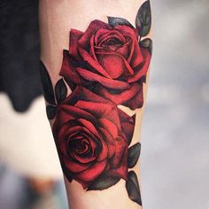 a woman's arm with red roses on it