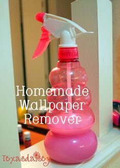 a pink spray bottle sitting on top of a white shelf next to a mirror with the words homemade wallpaper remover