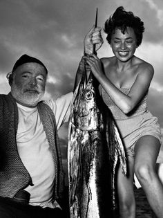 a man and woman pose with a fish