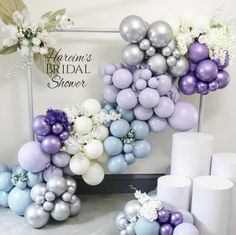 balloons and flowers are arranged in the shape of an arch for a bridal shower