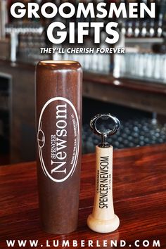 a bottle opener sitting on top of a wooden table next to a wine glass with the words baseball bat mugs and bottle openers