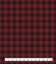 a red and black plaid fabric with a ruler