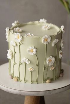 a green cake with white flowers on it